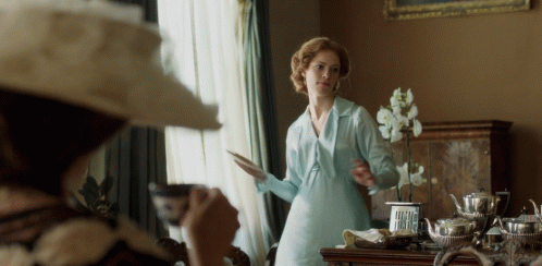 Woman throwing a saucer at a man in anger.